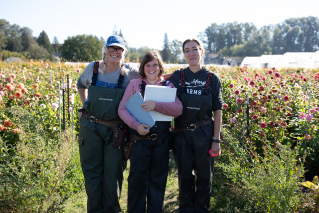 Erin Benzakein, Jill Jorgensen, and Nina in the Floret dahlia breeding field